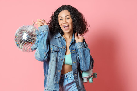 Happy woman with disco ball and roller skates on pink background