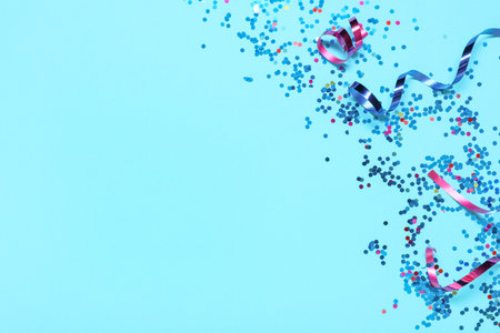 Beautiful confetti and serpentine on blue backgroundの写真素材