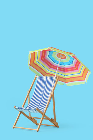 Striped deck chair with umbrella on blue background
