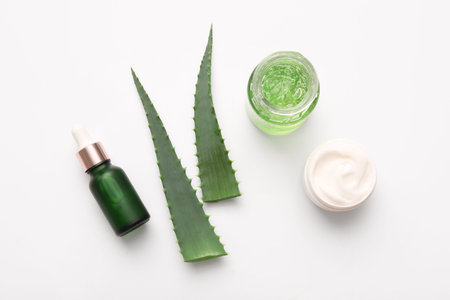 Different cosmetic products with aloe vera leaves on white backgroundの写真素材