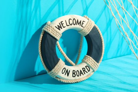 Mini lifebuoy, fish net and shadows on color background