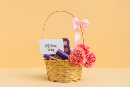 Basket with carnations, postcard and cosmetics for Mother's Day on beige backgroundの写真素材