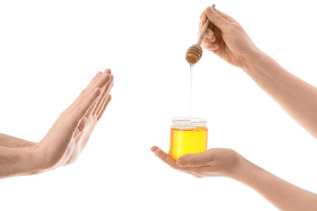 Man rejecting female hands with honey on white background. Food Allergy Awareness Monthの写真素材