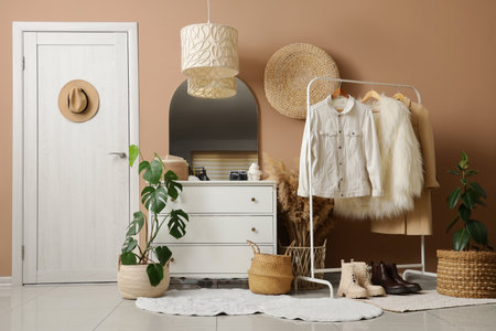 Interior of hallway with wicker baskets, clothes rack and doorの写真素材