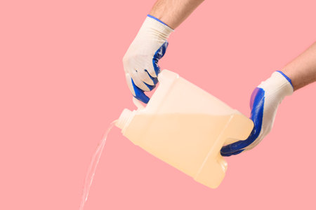 Male hands holding canister on pink backgroundの写真素材