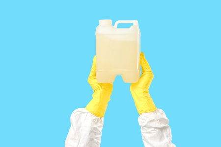 Hands holding canister on blue backgroundの写真素材