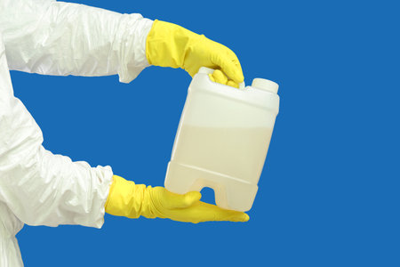 Hands holding canister on blue backgroundの写真素材