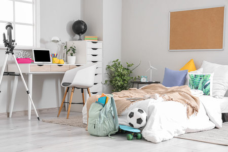 Interior of children's room with bed, study table and backpackの写真素材
