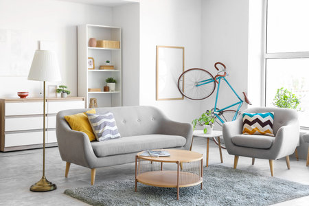 Interior of living room with bicycle, sofa and armchair
