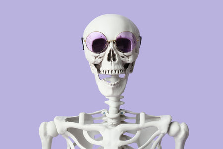 Funny human skeleton in sunglasses on lilac backgroundの写真素材