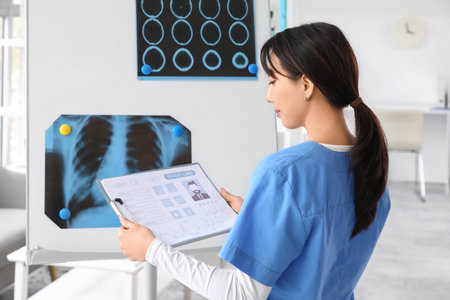 Female doctor with patient card in clinic, back view