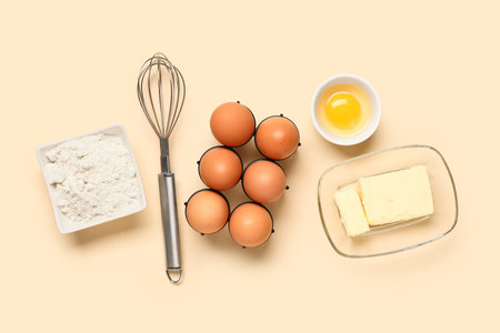 Composition with raw chicken eggs, flour, butter and whiskey on color backgroundの写真素材
