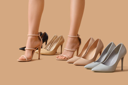 Legs of woman with stylish high heels on beige background, closeupの写真素材