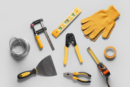 Wires and construction tools on gray background