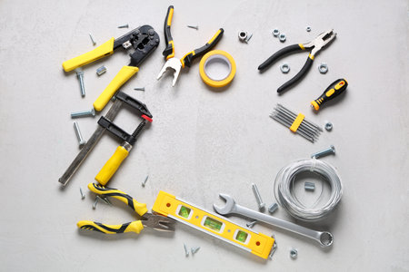 Frame made from construction tools on white grunge background