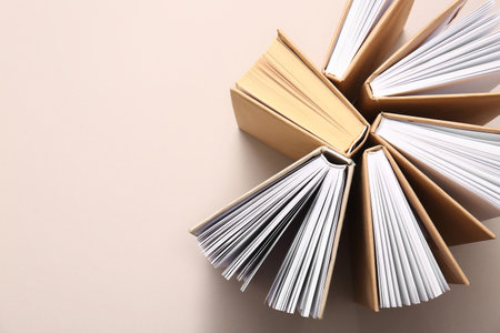 Composition with open books on beige backgroundの写真素材