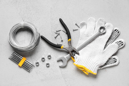 Wires and construction tools on white grunge background