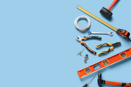 Wires and construction tools on blue background