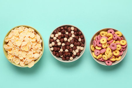 Composition with bowls of different tasty cereals on turquoise backgroundの写真素材