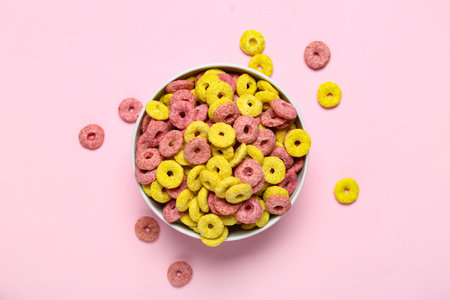 Bowl with tasty cereal rings on pink background, closeupの写真素材