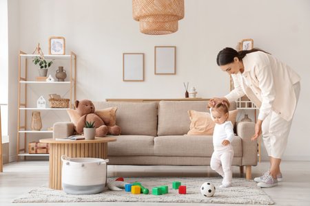 Mother playing with her baby at homeの写真素材