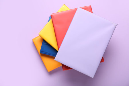 Many colorful books on lilac backgroundの写真素材