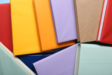 Many colorful books on blue background, closeupの写真素材