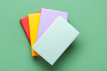 Many colorful books on green backgroundの写真素材