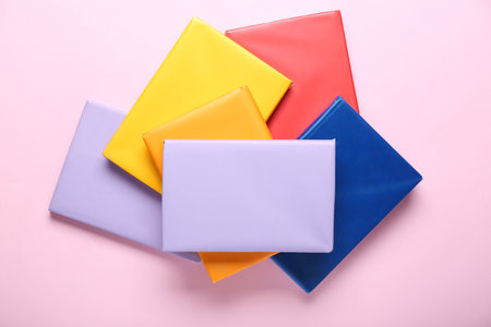 Many colorful books on pink backgroundの写真素材