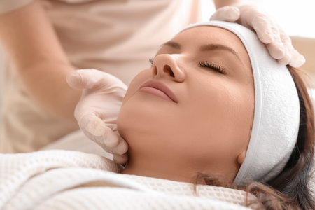 Female beautician with client in salon, closeupの写真素材