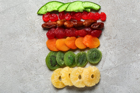 Different candied fruits on gray background