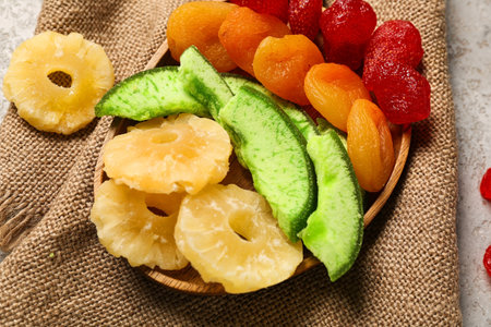 Wooden plate with different candied fruits on gray background, closeupの写真素材