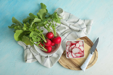 Bowls with fresh radishes on light blue backgroundの写真素材