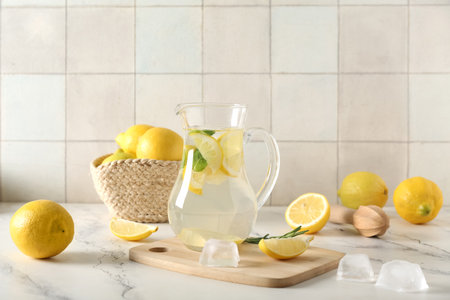 Glass of fresh lemonade with mint and lemons on white tableの写真素材