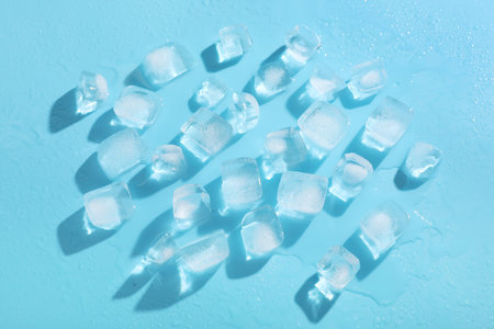 Many frozen ice cubes on blue backgroundの写真素材