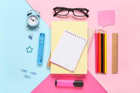 Composition with eyeglasses, alarm clock, notebooks and school supplies on color background, closeup