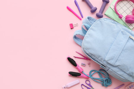 Composition with backpack, school supplies and sports equipment on pink backgroundの写真素材