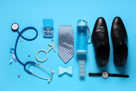 Male sign with ribbon, clothes, stethoscope and medicine on blue background. Prostate cancer awareness conceptの写真素材
