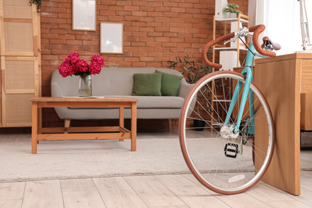 Modern bicycle near desk in home officeの写真素材