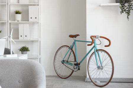 Modern bicycle in light home office interiorの写真素材