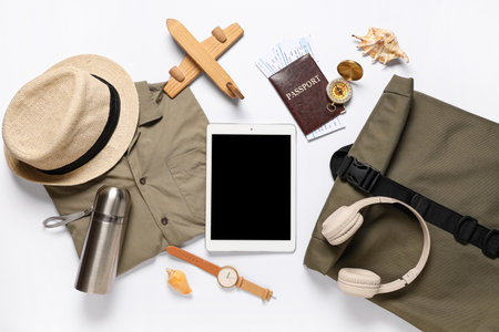 Composition with tablet, passport, tickets and accessories on white background, closeupの写真素材