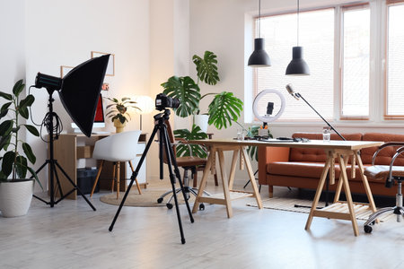 Interior of podcaster's studio with tables, sofa and plantsの写真素材