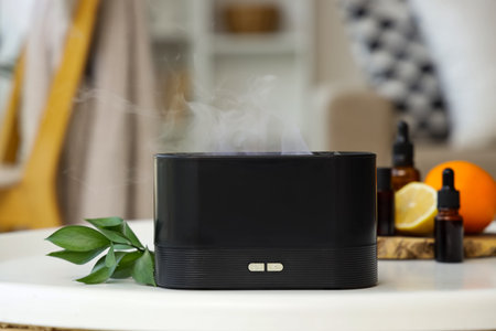 Air humidifier with essential oils and citruses on table in living room, closeup
