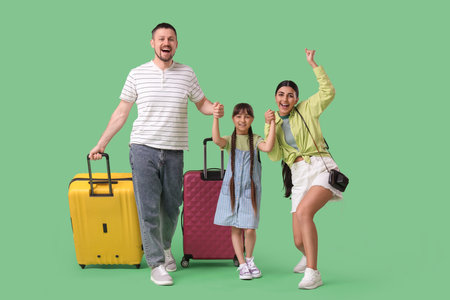Family of tourists with suitcases on green backgroundの写真素材