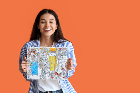 Young woman with painting by numbers on orange background