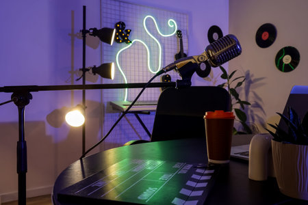 Podcaster's workplace with microphone in dark studio
