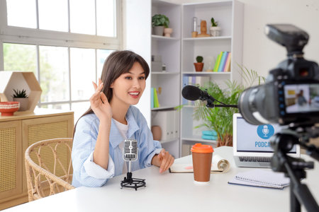 Young woman recording podcast in studio