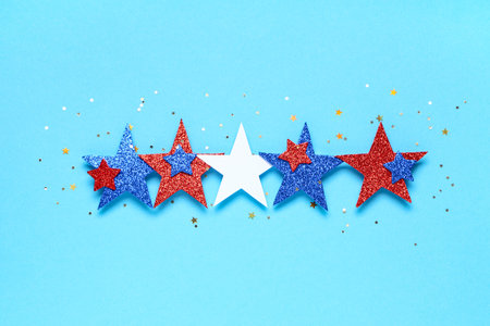 Glitter stars in colors of USA flag on blue background. Independence Day