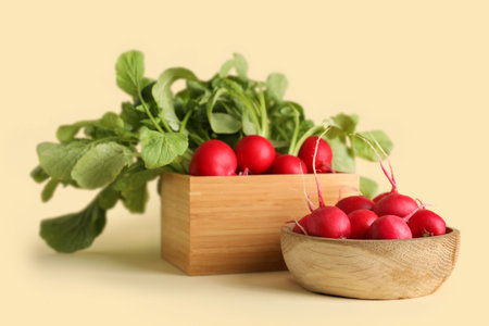 Bowl and box of ripe radish on beige background