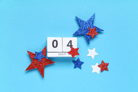 Cube calendar with date of Independence Day and stars on blue background